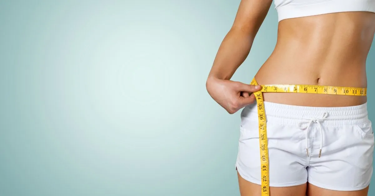 Woman measuring waist with tape for weight loss progress in Lee’s Summit MO